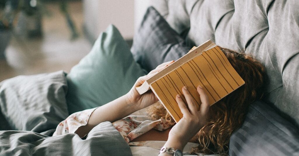 Woman resting in bed holding a book, creating a serene indoor atmosphere perfect for relaxation and leisure.